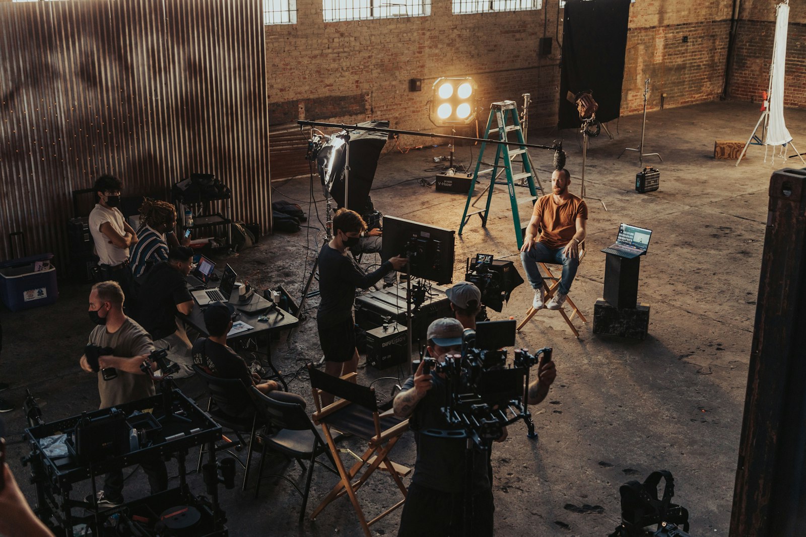 Professional media production team working around a camera setup